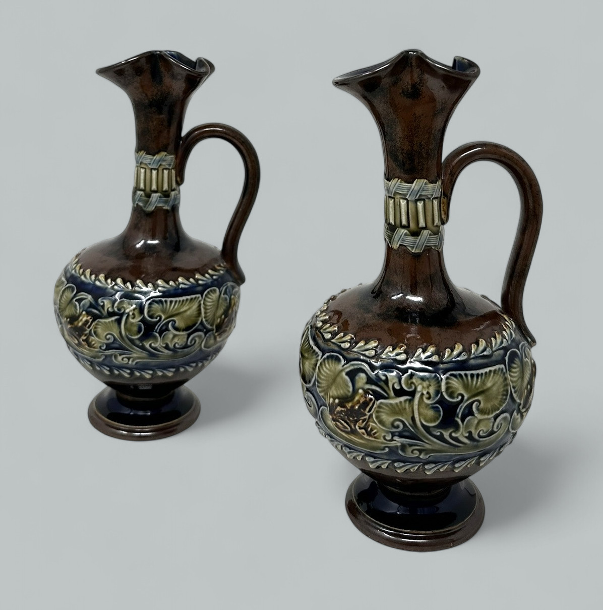 128. Antique Pair English Porcelain Royal Doulton Art Nouveau Ewers Pitchers Urns